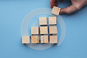 Hand choosing a wooden block from a set. Business choice concept