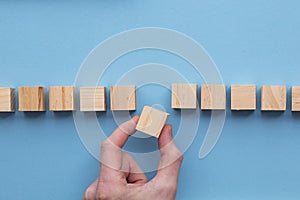 Hand choosing a wooden block from a set. Business choice concept