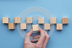 Hand choosing a wooden block from a set. Business choice concept