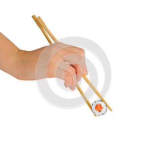 Hand with chopsticks eating maki roll, sushi with rice and salmon, isolated on white