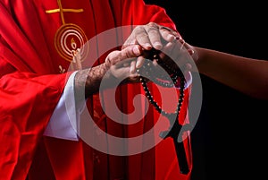Hand of christian pastor giving love and cross