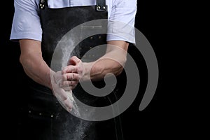 Hand clap of chef with flour on black background isolated