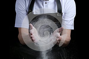 Hand clap of chef with flour on black background isolated