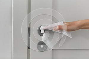 Hand cleaning door handle with antiseptic wet wipe