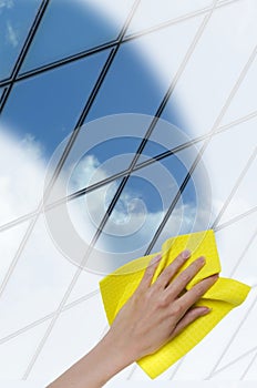 Hand cleaning a glass surface of a building