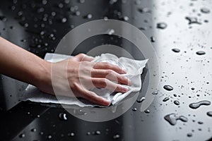 Hand cleaning liquid water drops with wipe tissue
