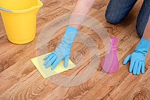 A hand cleaning a parquet