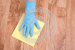 A hand cleaning a parquet