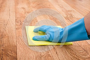 A hand cleaning parquet floor
