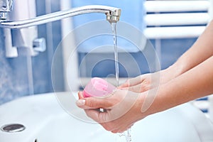 Hand cleaning with soap with runnung water photo