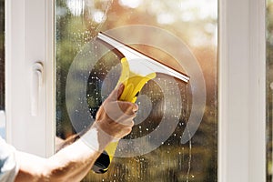 Hand cleaning window with vacuum cleaner photo