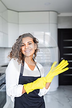 Hand cleaning.Young housewife woman washing dishes in kitchen.Preparing to clean,funny smiling photo with yellow rubber gloves.