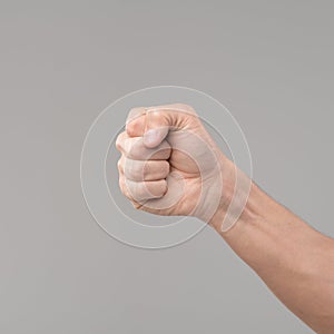 Hand with a clenched fist isolated