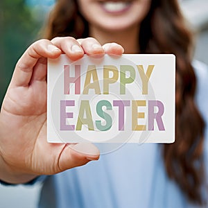 Hand close up woman displays greeting card titled Happy Easter