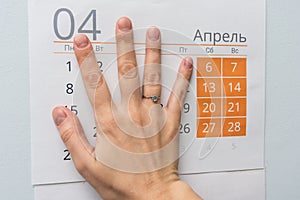 Hand closed weekdays on a sheet of calendar