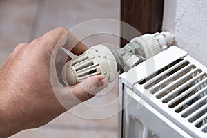 The hand that closes the radiator valve of the boiler in Europe, where there is a shortage of natural gas due to the Russian war