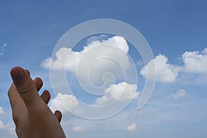 Hand and cloudy sky