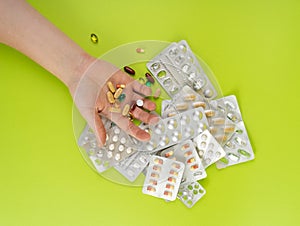 Hand with Color Pill Capsules on Green Background, Overdose Concept, Opioid Problem, Poison, Analgesic