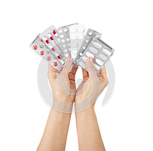 Hand and colorful medicines on a white background