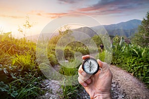 Hand with Compass in the mountains