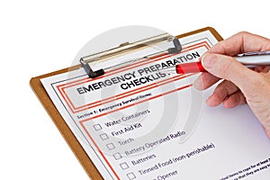 Hand completing Emergency Preparation List