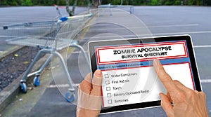 Hand completing Zombie Apocalypse survival checklist on a computer tablet - infront of empty supermarket carpark