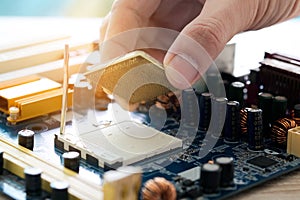 Hand of computer engineering brings computer cpu processor memory change components into socket processor for maintenance.Technolo