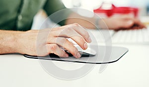 Hand, computer mouse and ecommerce with a business man working on a desktop in his company office. Marketing, software