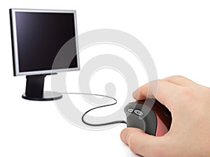 Hand with computer mouse and monitor