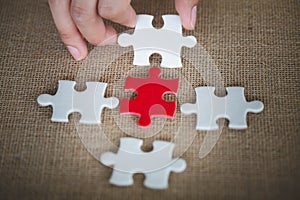 Hand connect white and red jigsaw parts with word problem & solution.   symbol of association and connection. business strategy.