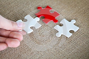 Hand connect white and red jigsaw parts with word problem & solution.   symbol of association and connection. business strategy.