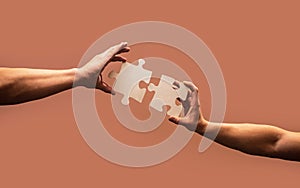 Hand connecting jigsaw puzzle. Business solutions, success and strategy concept. Man hands connecting couple puzzle