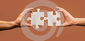 Hand connecting jigsaw puzzle. Man hands connecting couple puzzle piece. Closeup hands of man connecting jigsaw puzzle