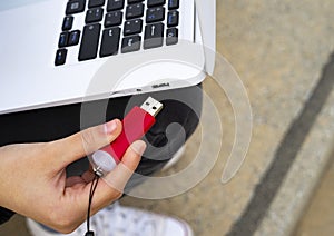 Hand connecting a Pendrive to the laptop