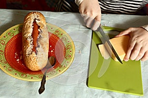 Hand cooking hot dog with sausage baguette cheese
