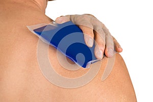 Hand with cool gel pack on shoulder