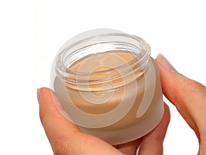 Hand with a cosmetic cream