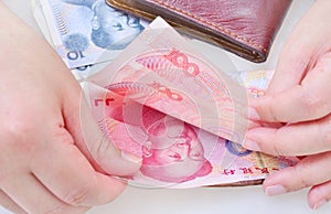 Hand counting Chinese yuan banknotes.