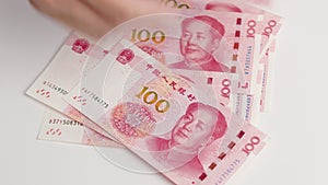 Hand counting passing Chinese yuan money currency , hand giving money RMB banknotes Chinese yuan moneybanknotes