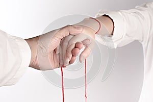 A hand of couple touch each other. The Faith of red thread brings destiny photo