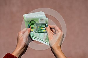 Hand couting holding and showing euro money or giving money. World money concept, 100 EURO banknotes EUR currency isolated with