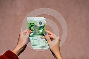 Hand couting holding and showing euro money or giving money. World money concept, 100 EURO banknotes EUR currency isolated with