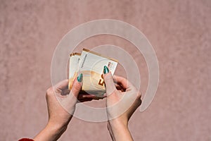 Hand couting holding and showing euro money or giving money. World money concept, 50 EURO banknotes EUR currency  with