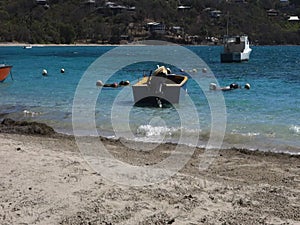 Hand-crafted boats bobbing in the surf at friendship bay, bequia