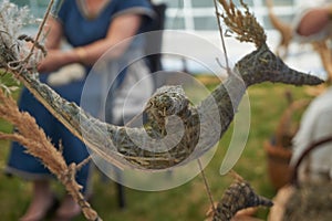 Hand-crafted flying bird made from dried grass