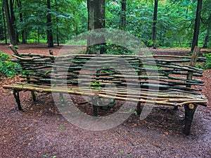 Hand crafted forest bench made of some branches