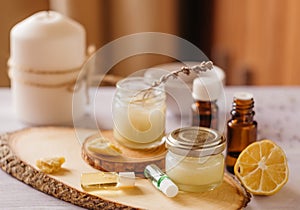 Hand cream and lip balm in a glass jar. Natural organic cosmetics with honey, wax and oils. photo