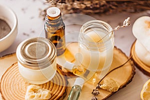 Hand cream and lip balm in a glass jar. Natural organic cosmetics with honey, wax and oils. photo