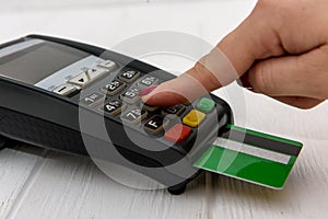 Hand with credit card and banking terminal