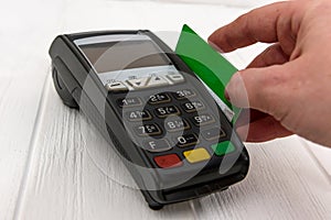Hand with credit card and banking terminal